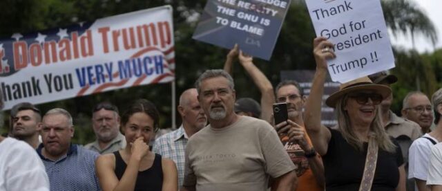 SA Whites A few white South Africans gathered outside the U.S. Embassy in Pretoria, supporting President Donald Trump. The protesters, numbering in the hundreds, carried signs that read “Thank God for President Trump”
