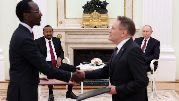 Russia's President Vladimir Putin and Ethiopia’s Prime Minister Abiy Ahmed look on.